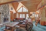 Black Bear Lodge living room with leather furniture and wood fireplace. 